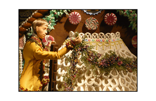 Man Decorating Candy House