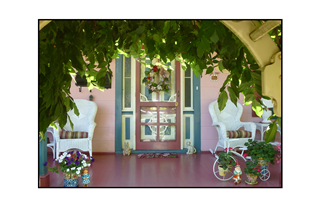 Cape May porch with white wicker chairs and figurines