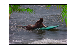 surfer girl waiting for the next wave