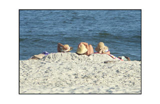 women holding onto their bonnets while looking at bay