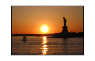 New York City Sunset with sailboat and Statue of Liberty