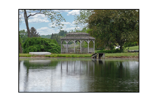 rowboat, gazebo, and dock by a lake