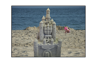 sandcastle with little girl in pink