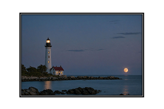 seaside lighthouse at twilight with moon