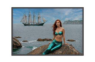 sexy mermaid on rock with ship in background