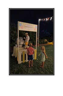 cotton candy stand with kids and bubbles in the background