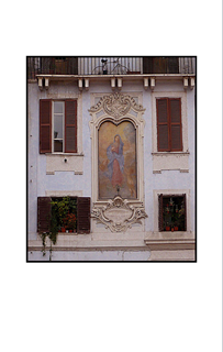 Blessed Mother in Italy with bicycle and Italian window shutters